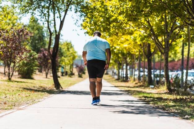 back-view-elderly-black-man-with-overweight-problems-running-park_137071-39.jpg