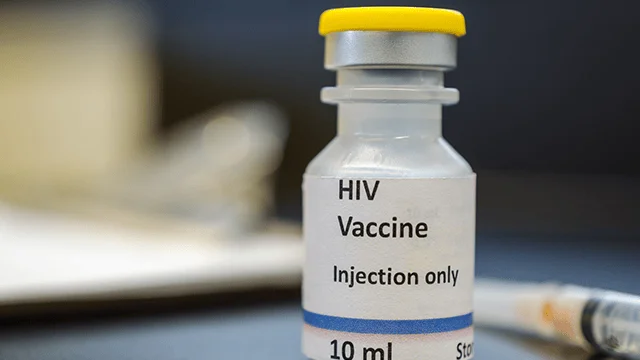Frasco de 10 ml etiquetado 'HIV Vaccine – Injection only' junto a una jeringa.