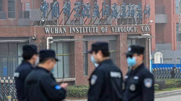 Guardias de seguridad con mascarillas montan guardia frente al Wuhan Institute of Virology, CAS.