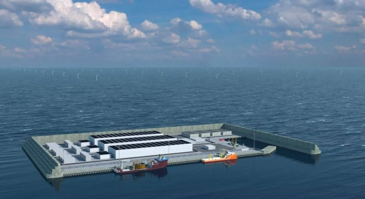 Render de una isla artificial en el mar con instalaciones eléctricas, barcos atracados y turbinas eólicas offshore al fondo.
