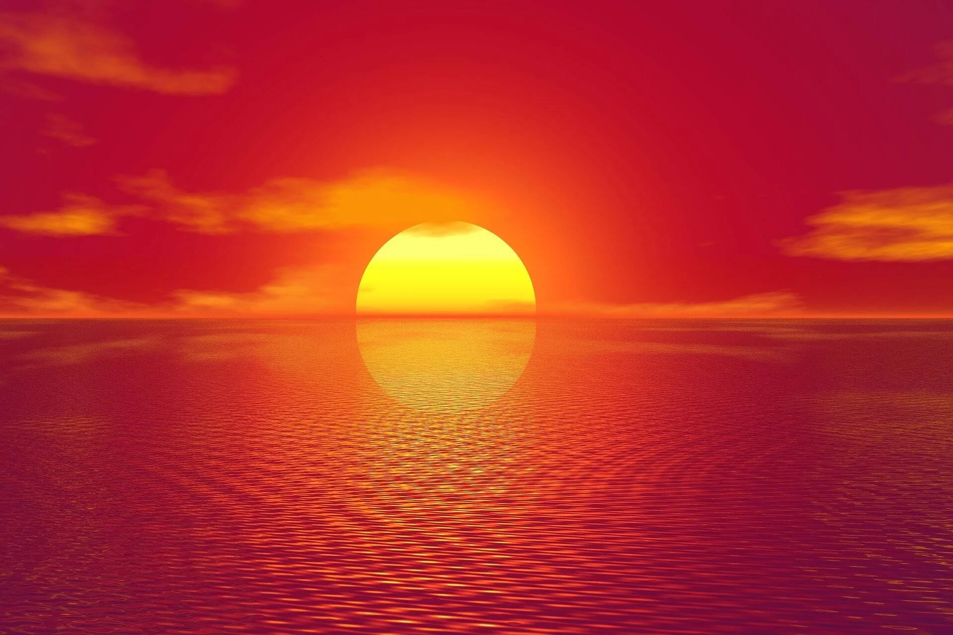 Sol grande y redondo hundiéndose en el horizonte del océano bajo un cielo completamente rojo, con su reflejo en el agua.