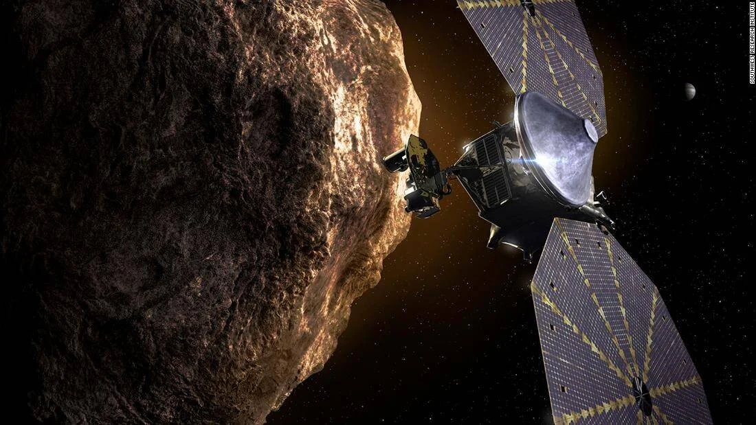 Ilustración artística de una nave espacial con paneles solares acercándose a un gran asteroide rocoso en el espacio.
