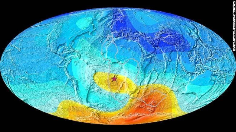 Mapa mundial del campo magnético terrestre con una estrella marcando la Anomalía del Atlántico Sur, con zonas en rojo, amarillo y azul.