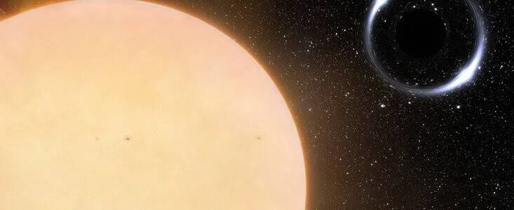 Representación artística de un agujero negro con anillo de luz orbitando junto a una estrella amarilla gigante en el espacio.
