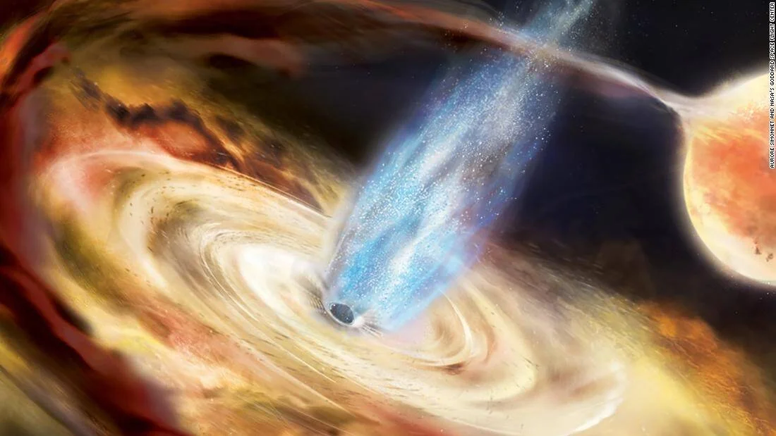 Ilustración de un agujero negro rodeado por un disco de acreción que emite un potente chorro de energía azul hacia el espacio.