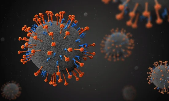 Representación tridimensional de partículas de coronavirus con espículas naranjas y azules sobre fondo oscuro.