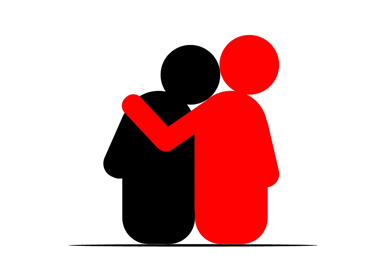 Figura roja abraza a figura negra por el hombro, simbolizando apoyo, solidaridad o acompañamiento emocional.