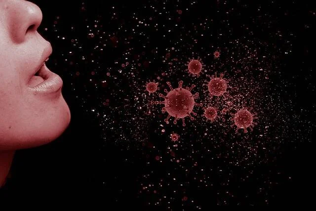 Ilustración de una persona exhalando gotículas con partículas de virus visibles en el aire sobre fondo oscuro.