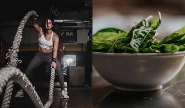 Mujer haciendo ejercicio con battle ropes en un gimnasio junto a un tazón con hojas frescas de espinaca.