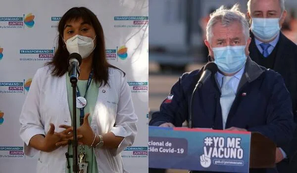 Dos autoridades sanitarias chilenas con mascarilla hablan ante micrófonos durante la campaña de vacunación Covid-19.